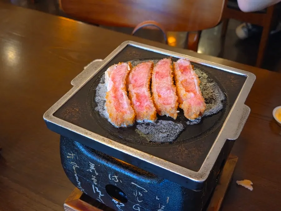 Sirloin gyukatsu being grilled on the brazier