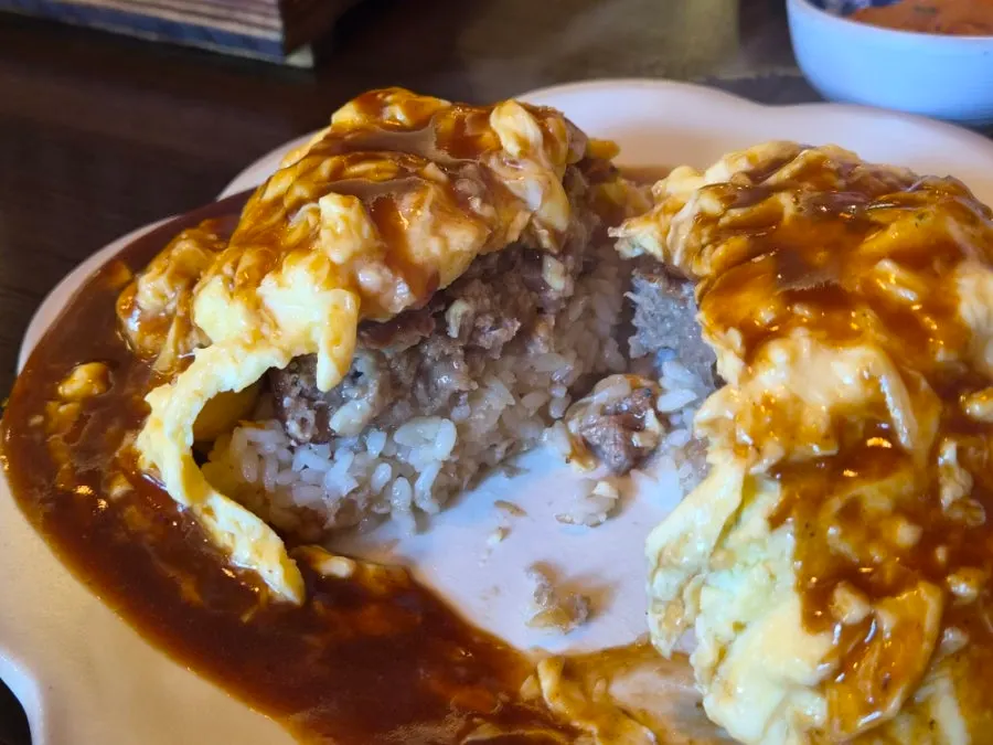 A spoonful with egg, rice, and hamburger steak together