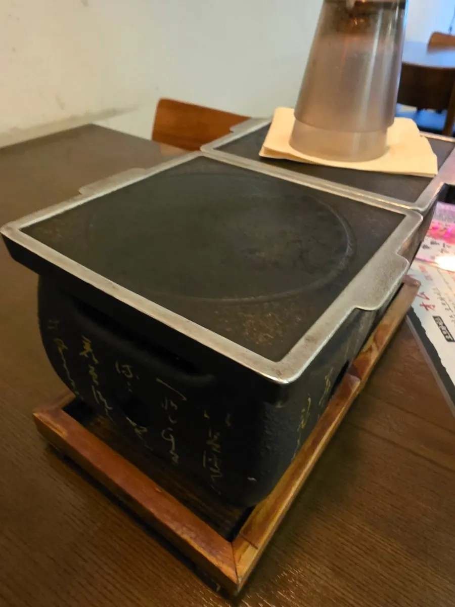Personal charcoal grill set up at the table
