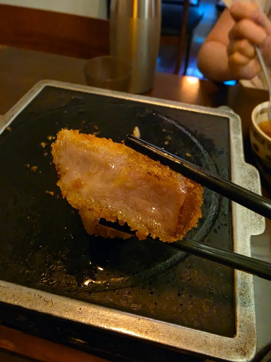 A piece of tenderloin gyukatsu dipped in salt