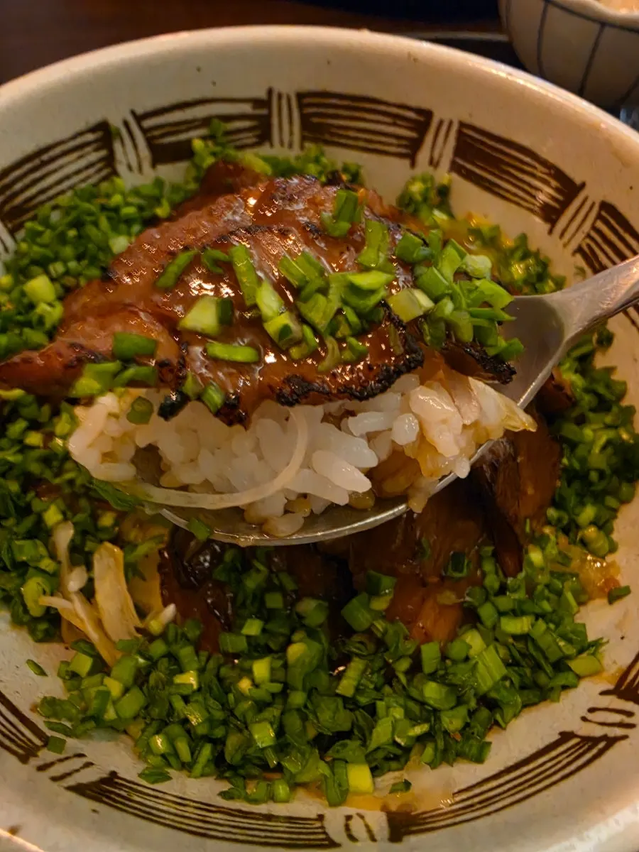 A bowl of steki rice mixed with the egg yolk