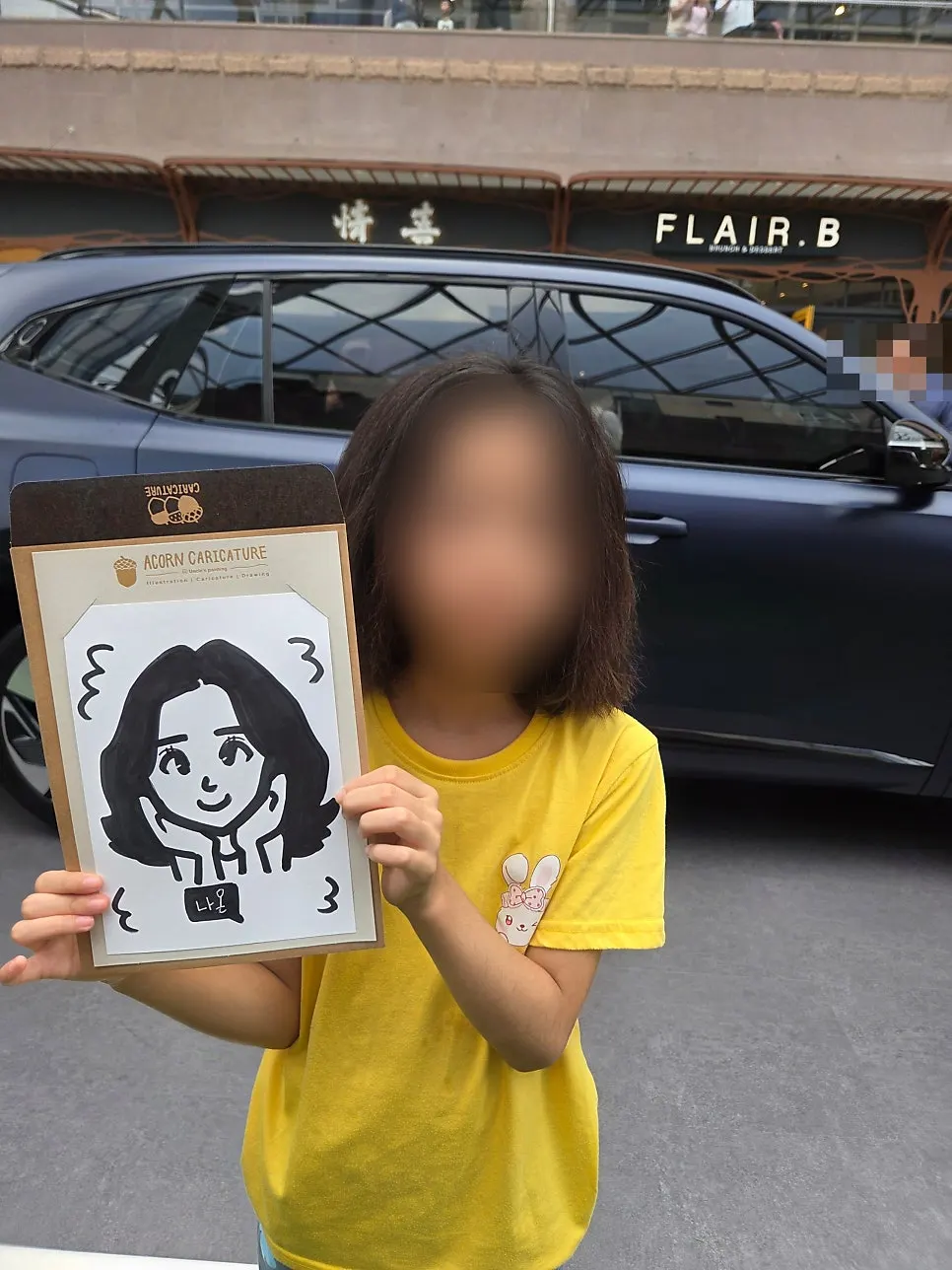 Souvenir photo holding the finished caricature