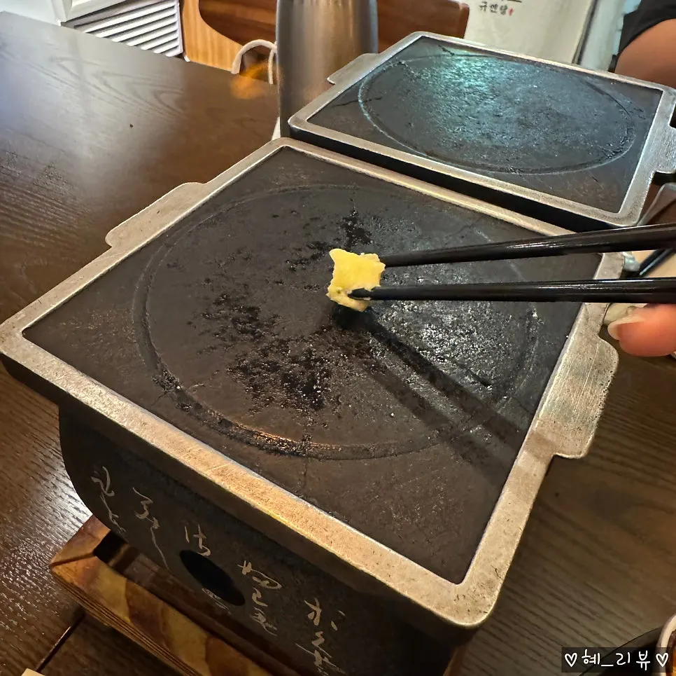 A piece of gyukatsu cooking on the buttered grill