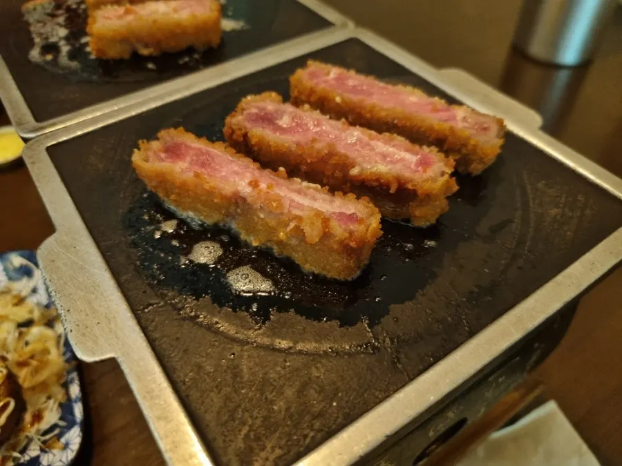 Meat sizzling on the small tabletop burner