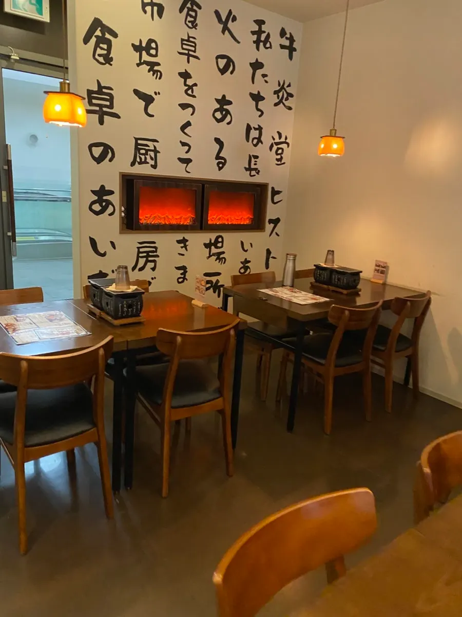 Table with hearth grill in the back of the restaurant