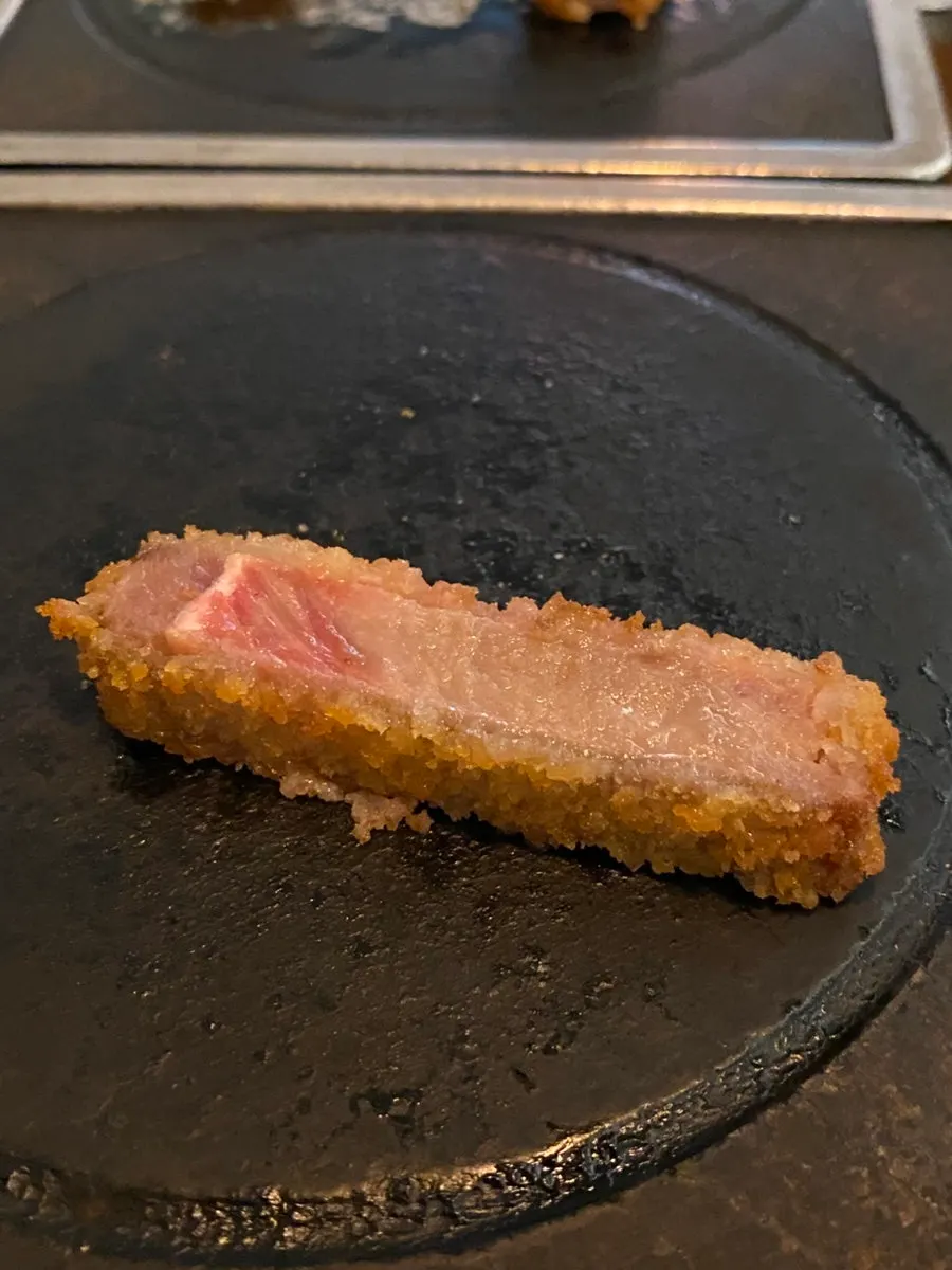 A piece of sirloin gyukatsu placed on the hearth