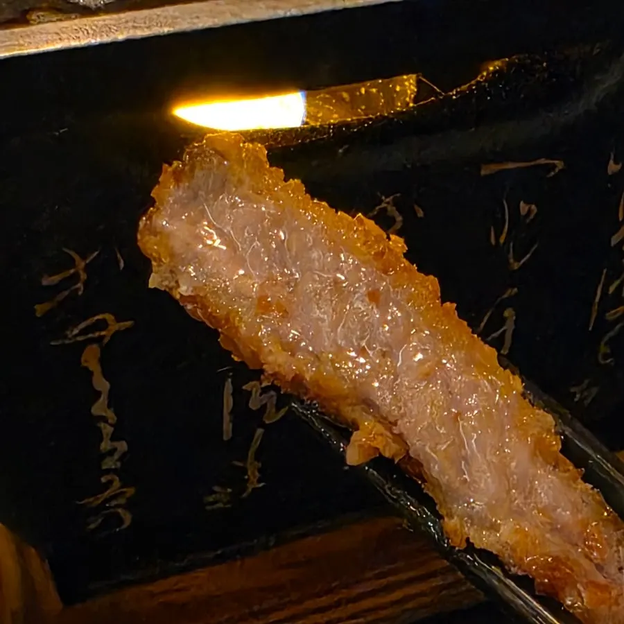 Flipping the gyukatsu during grilling