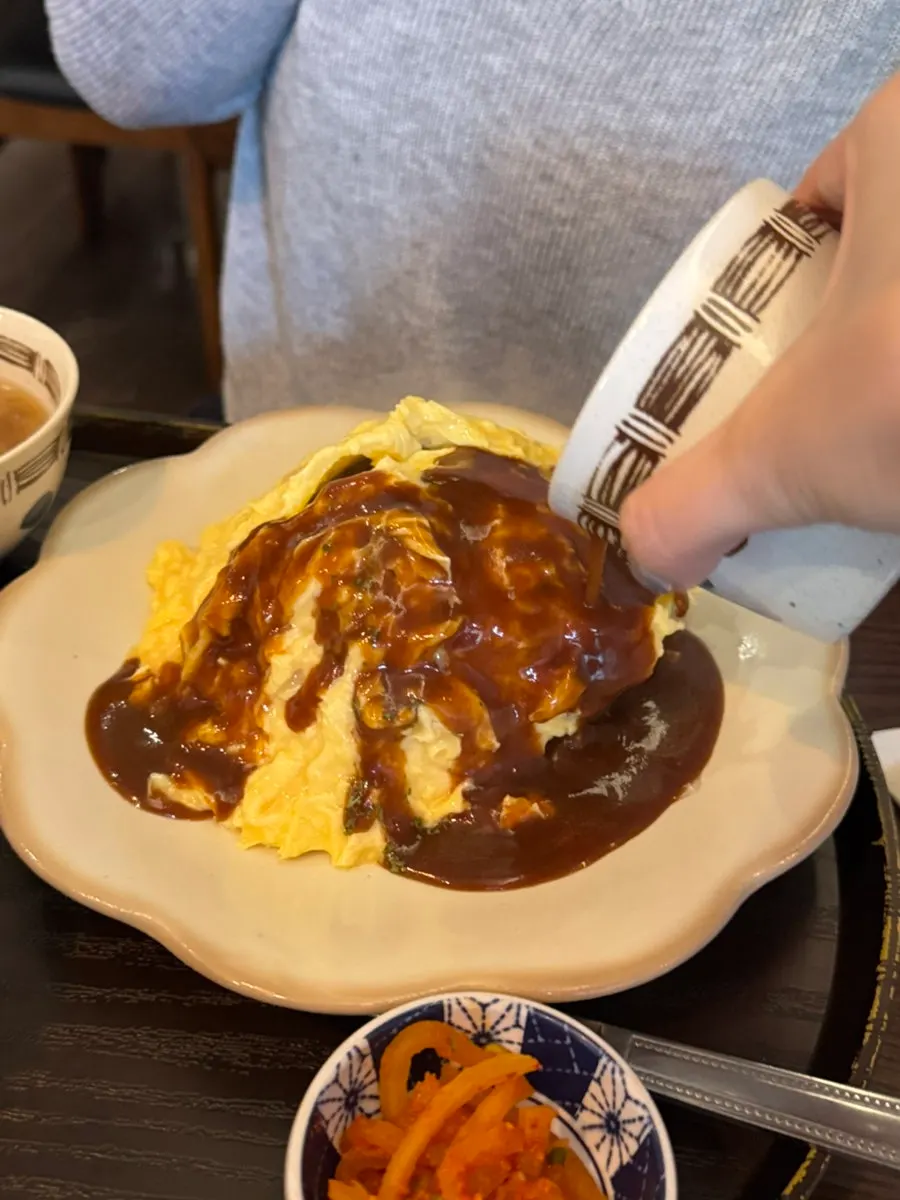 A spoonful of egg, hamburg steak, and rice together