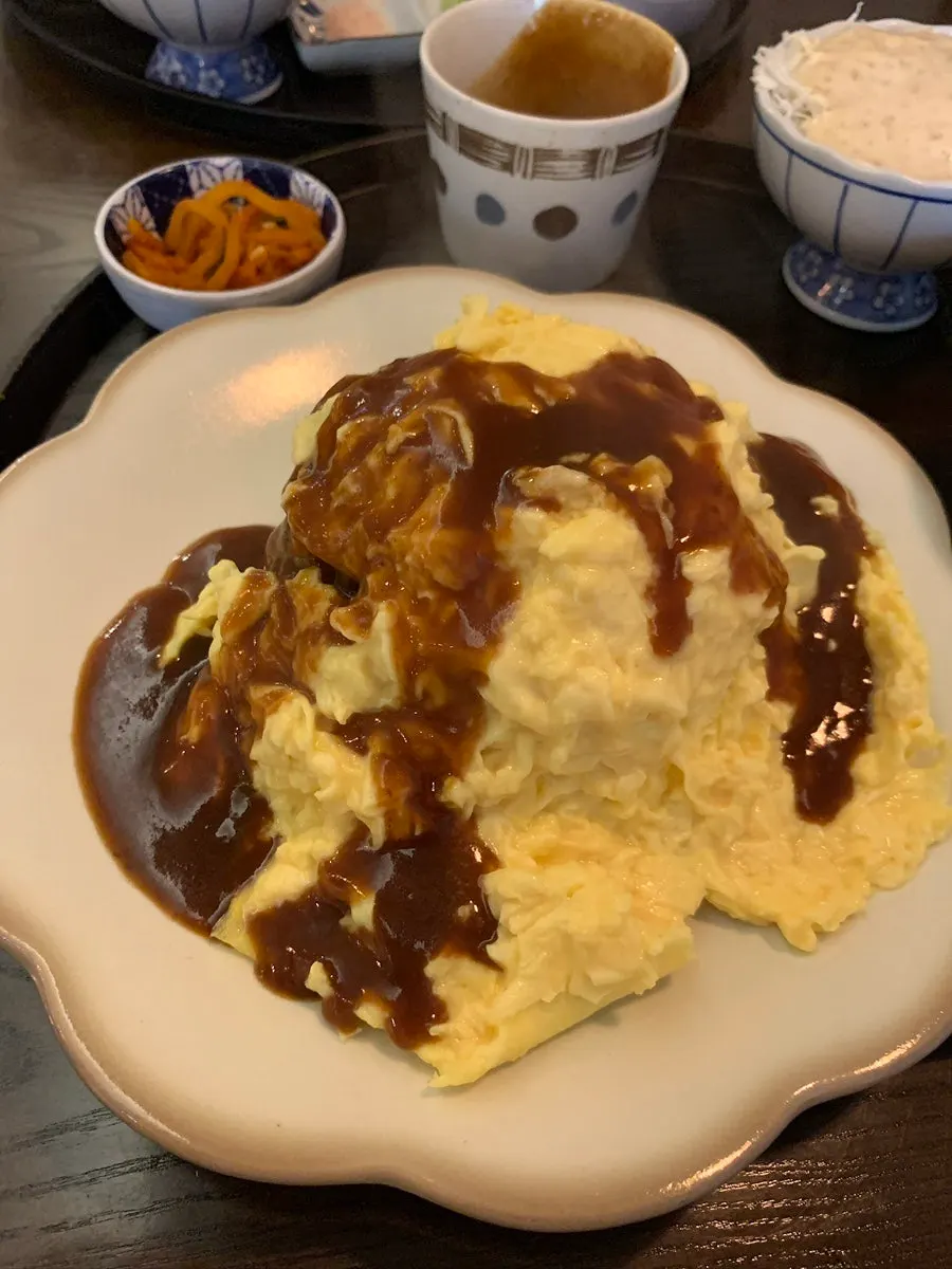 Sliced omurice revealing soft, jiggly egg inside