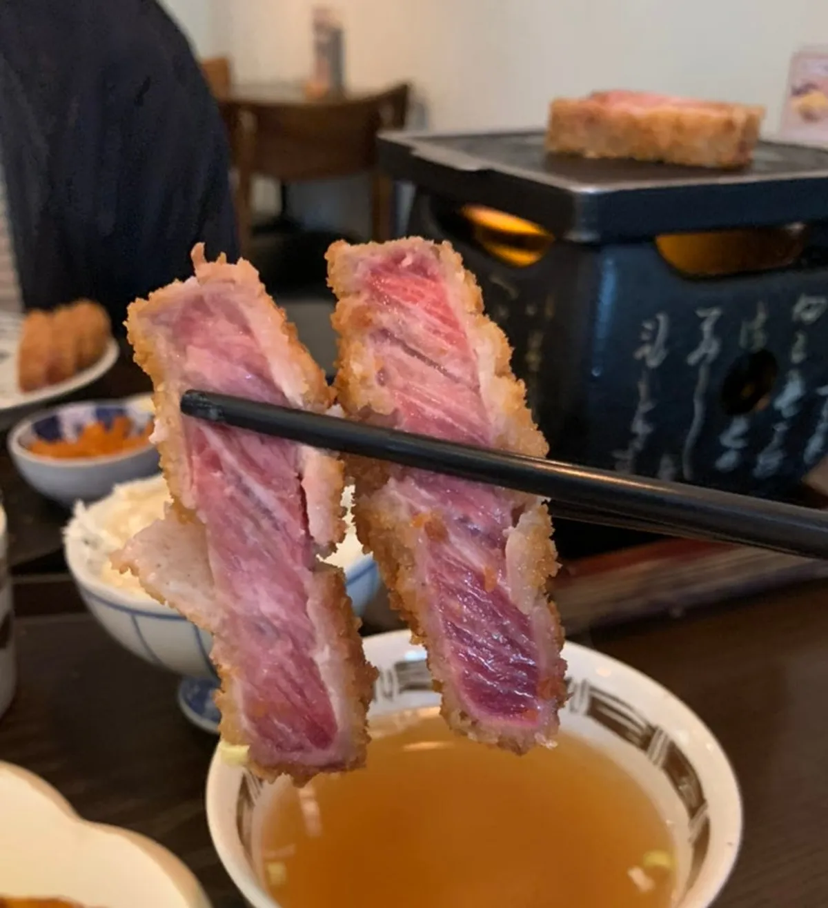 Two pieces of sirloin gyukatsu on the grill plate