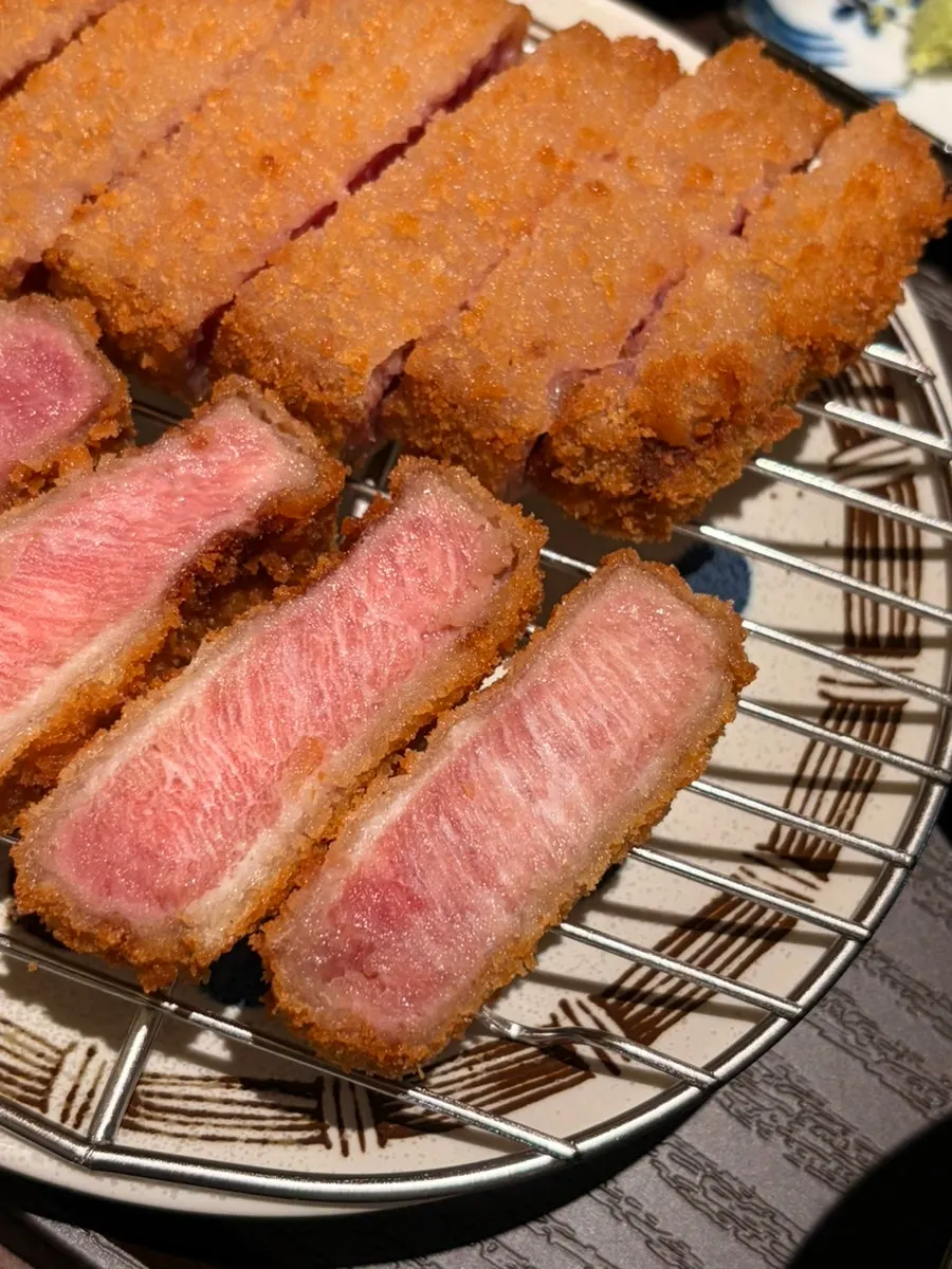 A piece of tenderloin gyukatsu dipped in sauce