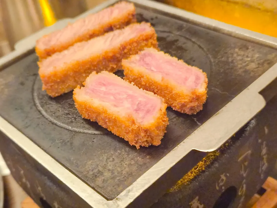 A piece of gyukatsu placed on the grill