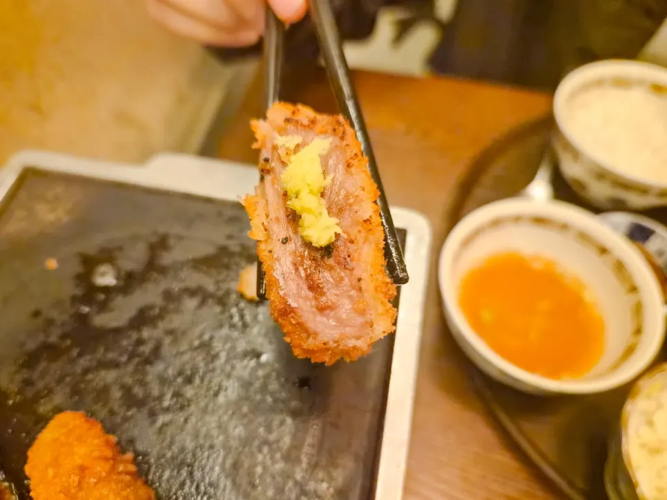 A piece of gyukatsu topped with wasabi