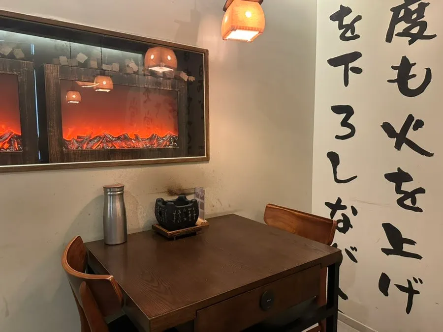 Interior with wall lettering and wood-tone tables
