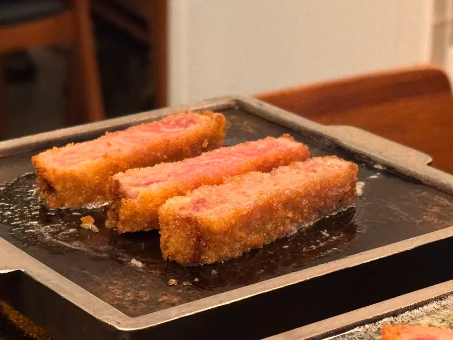 A piece of striploin beef katsu topped with fresh wasabi