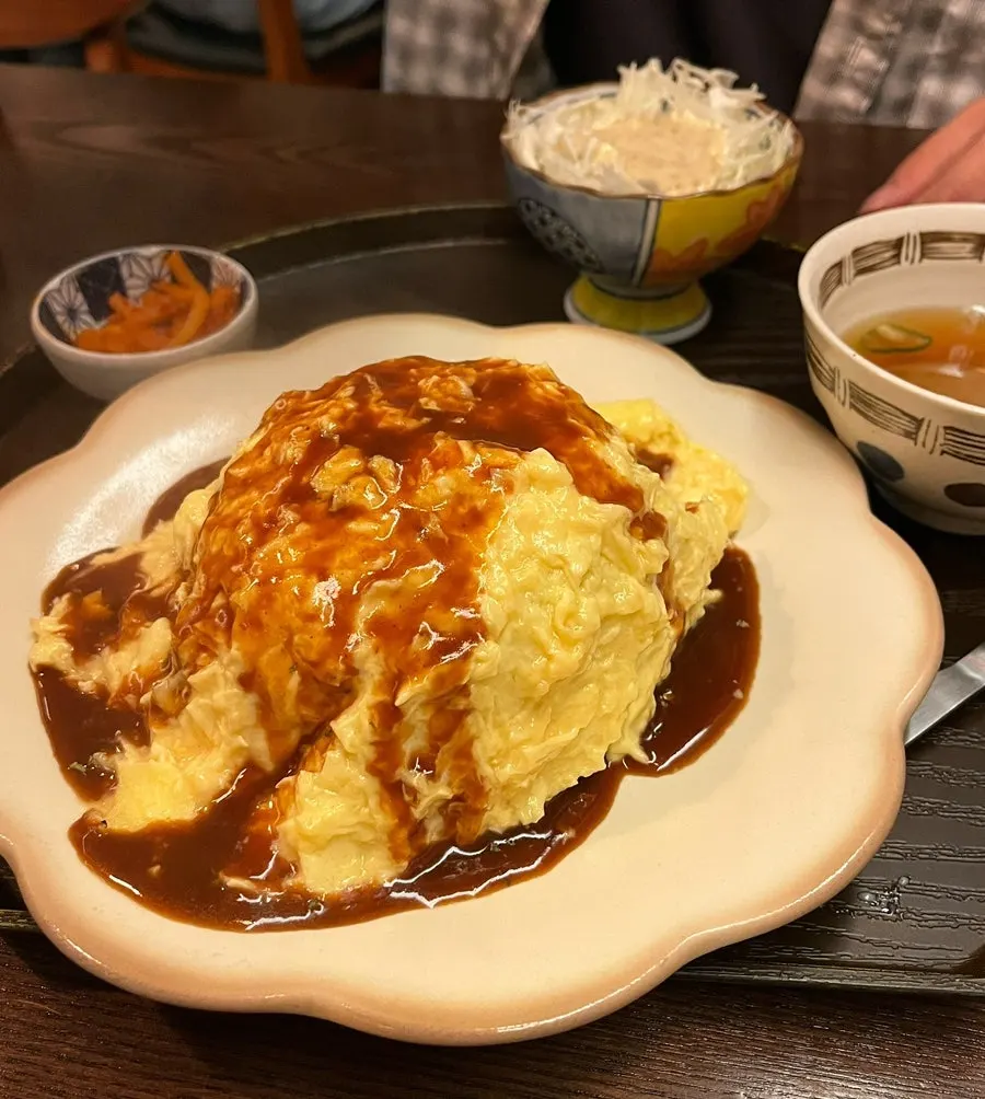 Hamburg steak and sauce inside the omelet rice
