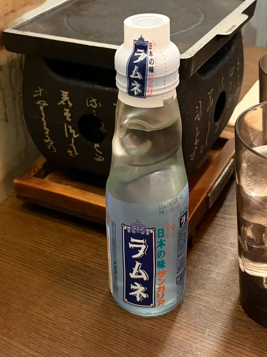 Gyukatsu, omelet rice, and ramune soda laid out on the table