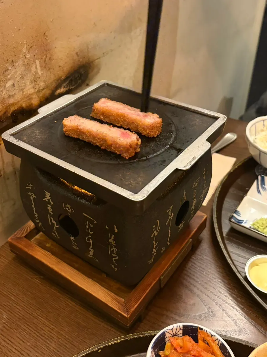 Tabletop grill and gyukatsu spread with wasabi, salt, and house sauce