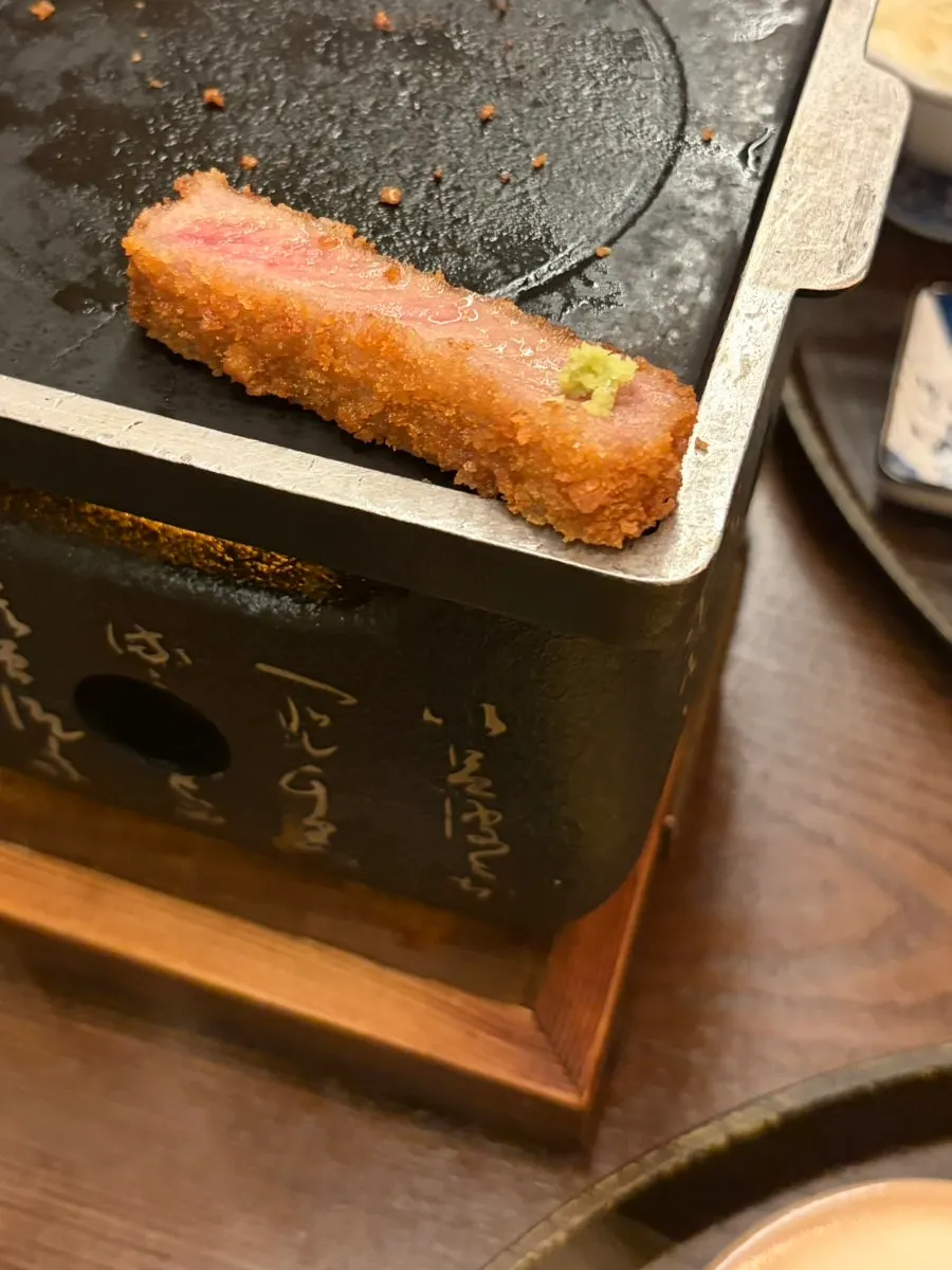 Striploin gyukatsu being grilled front and back on the tabletop burner