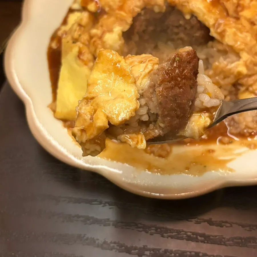 A spoonful of moist egg and hamburg patty from the omelet rice
