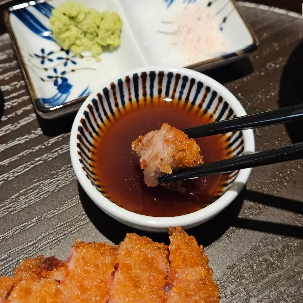 A piece of sirloin gyukatsu dipped in the special sauce