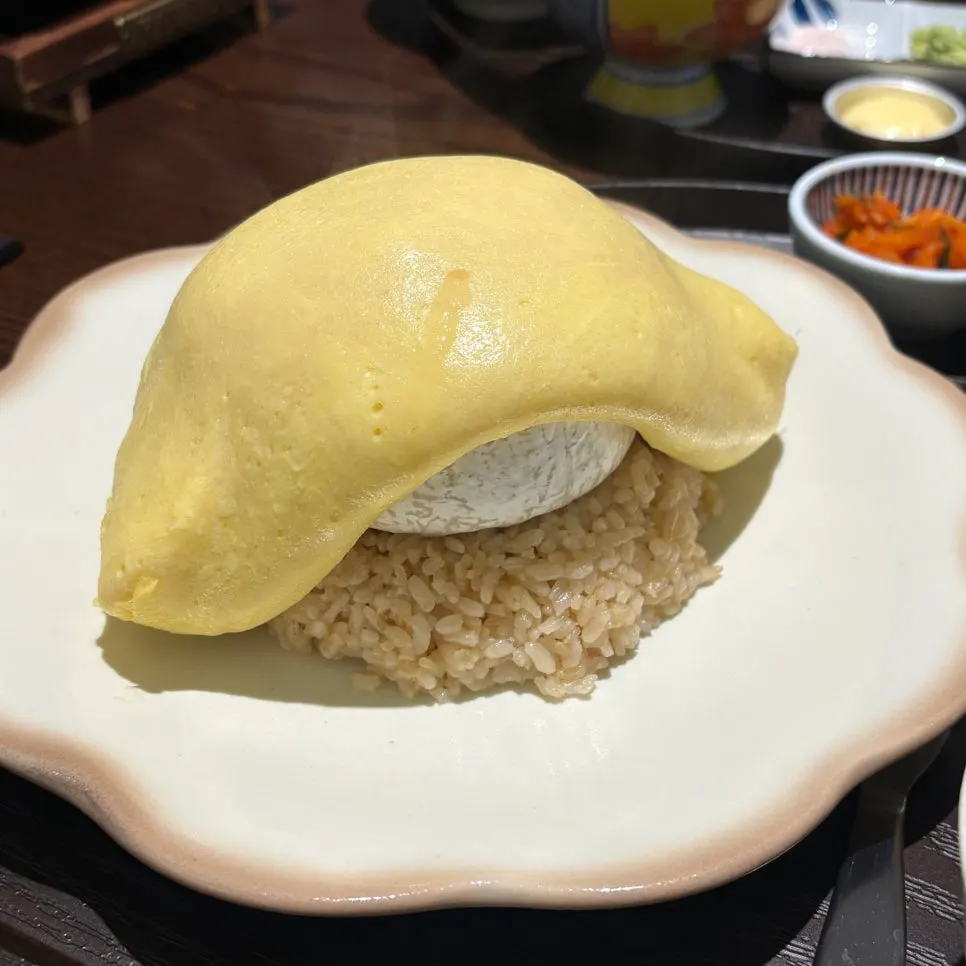 Brie cheese omurice topped with a whole chunk of brie cheese