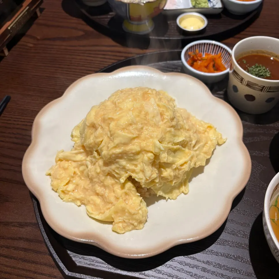 Egg blanket of the omurice sliced open with a knife
