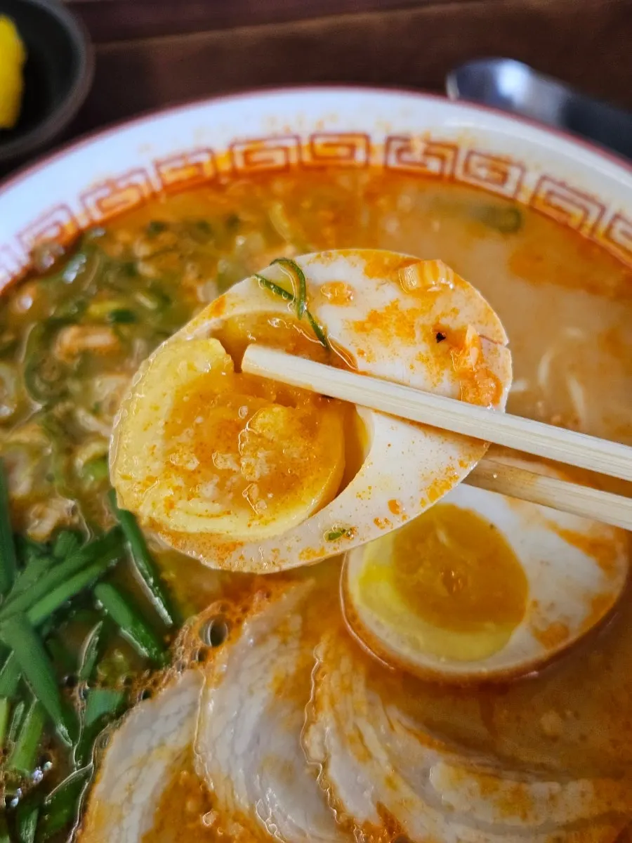 A soft-boiled egg dipped in the Taiwan ramen broth