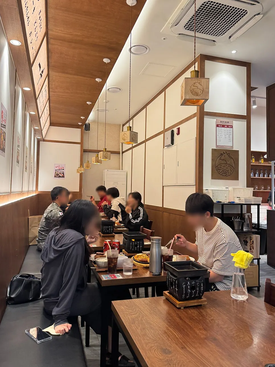 Wood-toned interior seating at Ichigyu Wonju