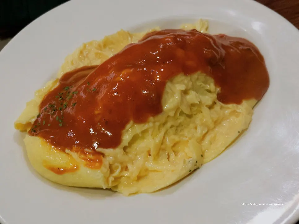 Plate of Japanese-style omurice with sauce poured over it