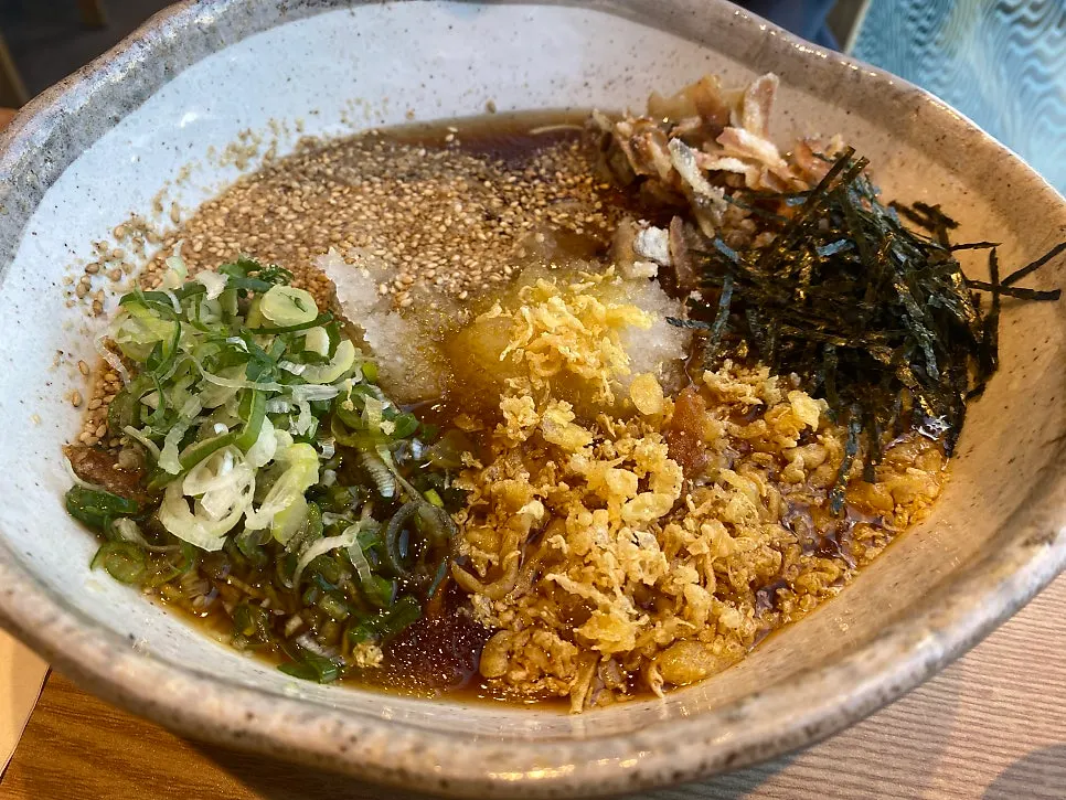 A bowl of yuzu-scented cold ramen topped with garnishes