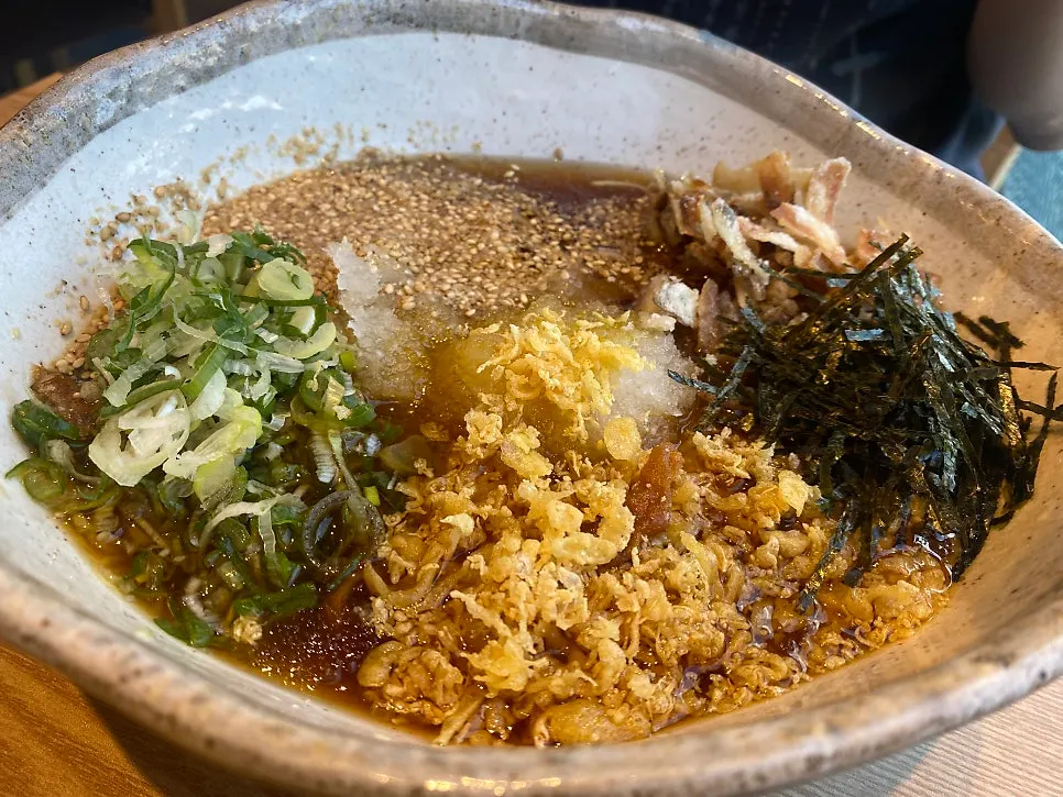 Noodles lifted from the cold ramen bowl