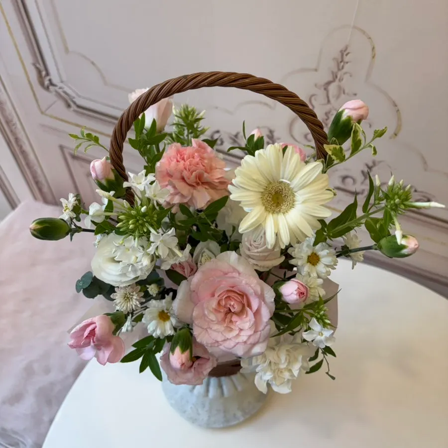 Watering the mini flower basket for upkeep