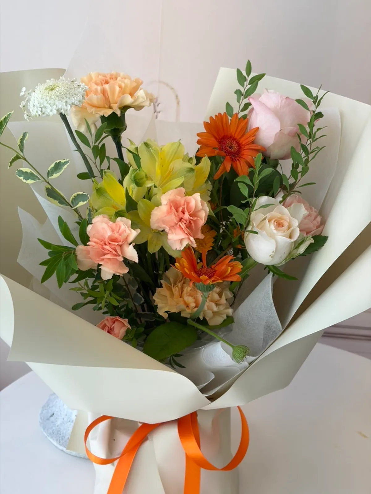 The ordered orange-toned S-size bouquet