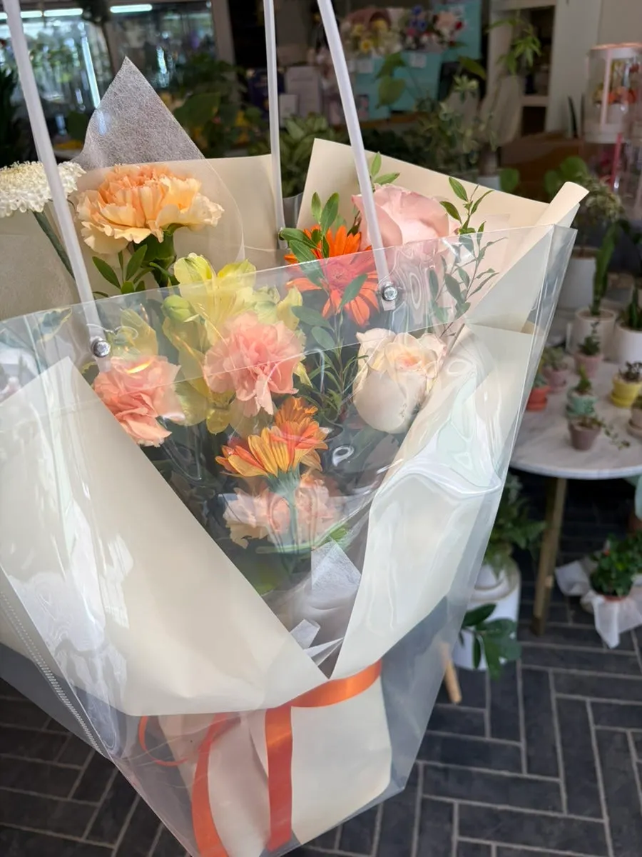Carrying the bouquet in its clear bag wrap