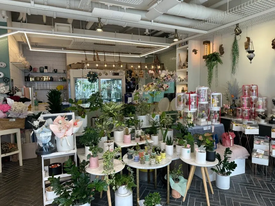 Fresh and artificial flower bouquets displayed together in the shop