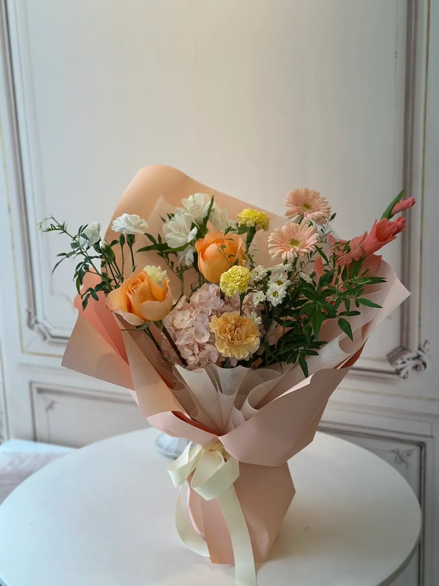 The full orange-peach fresh bouquet received