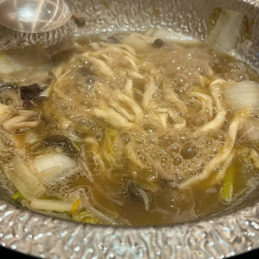 A bite combining vegetables and meat