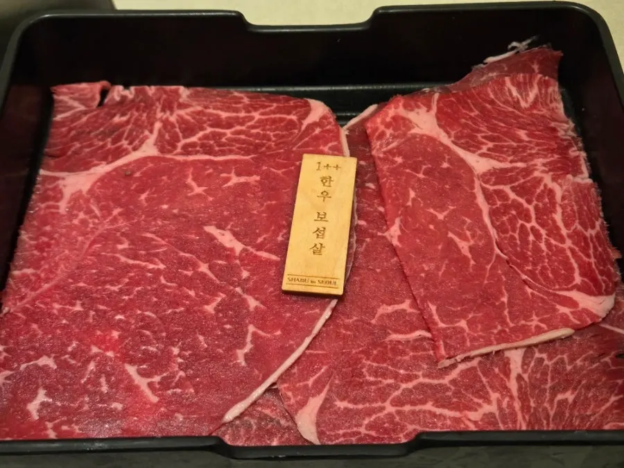 Finely marbled 1+2 grade hanwoo top sirloin on a plate
