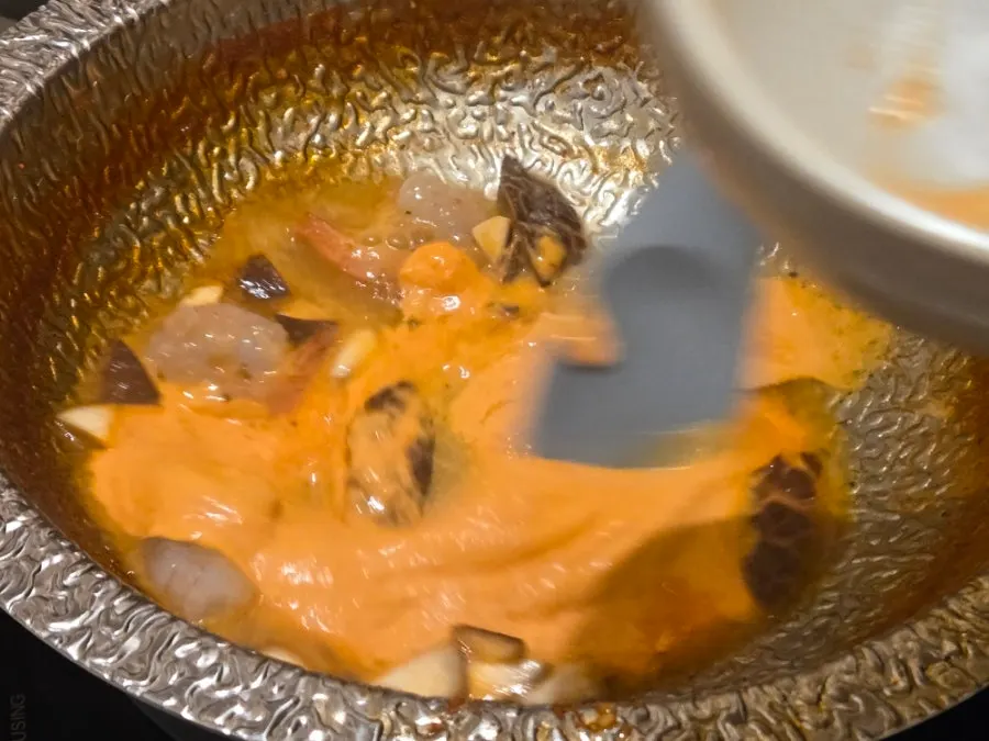 Rose risotto cooking in the spicy mushroom broth base