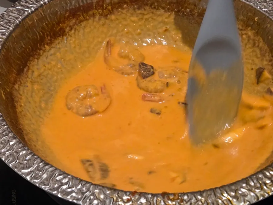 Cheese being stirred into the rose risotto