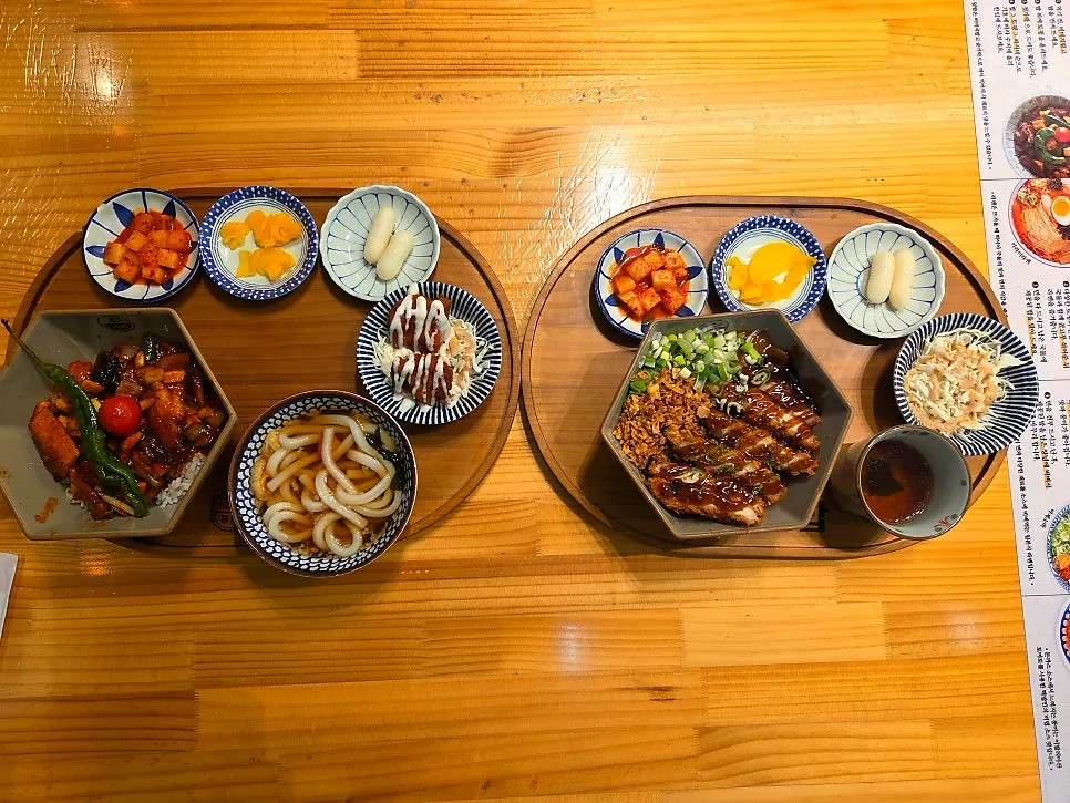Full table spread of the pork jowl rice bowl set and tonkatsu curry