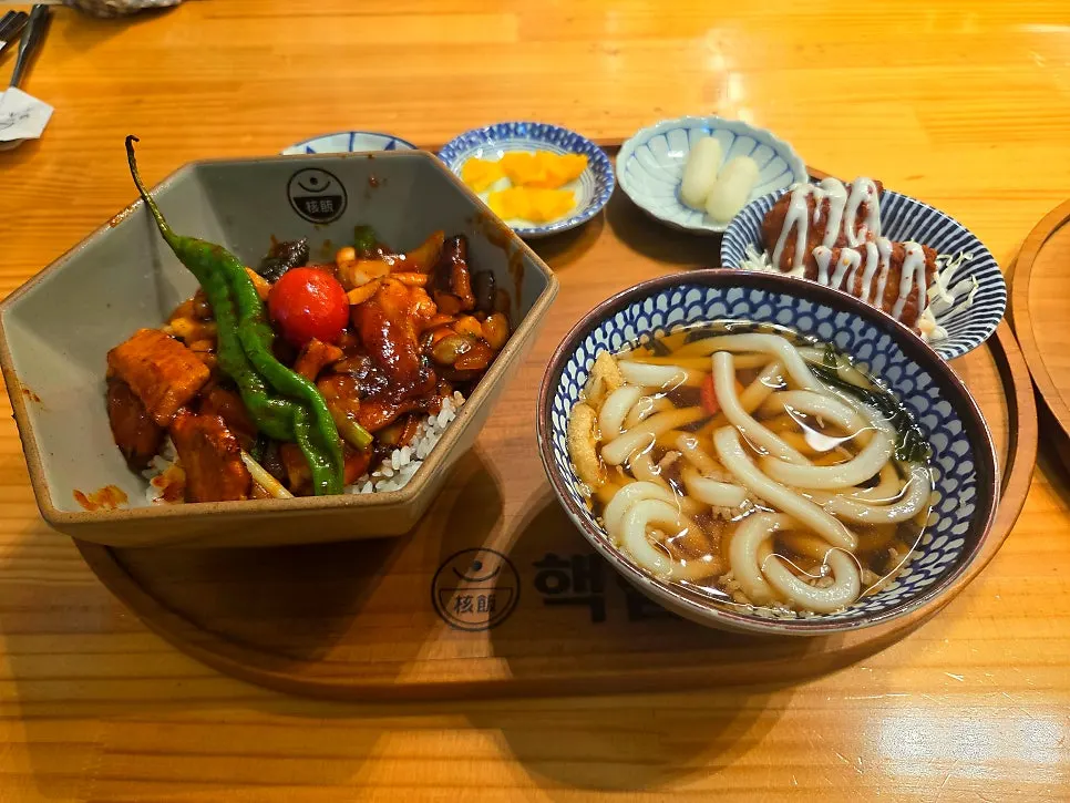 Table with rice bowl, curry, and fried items together