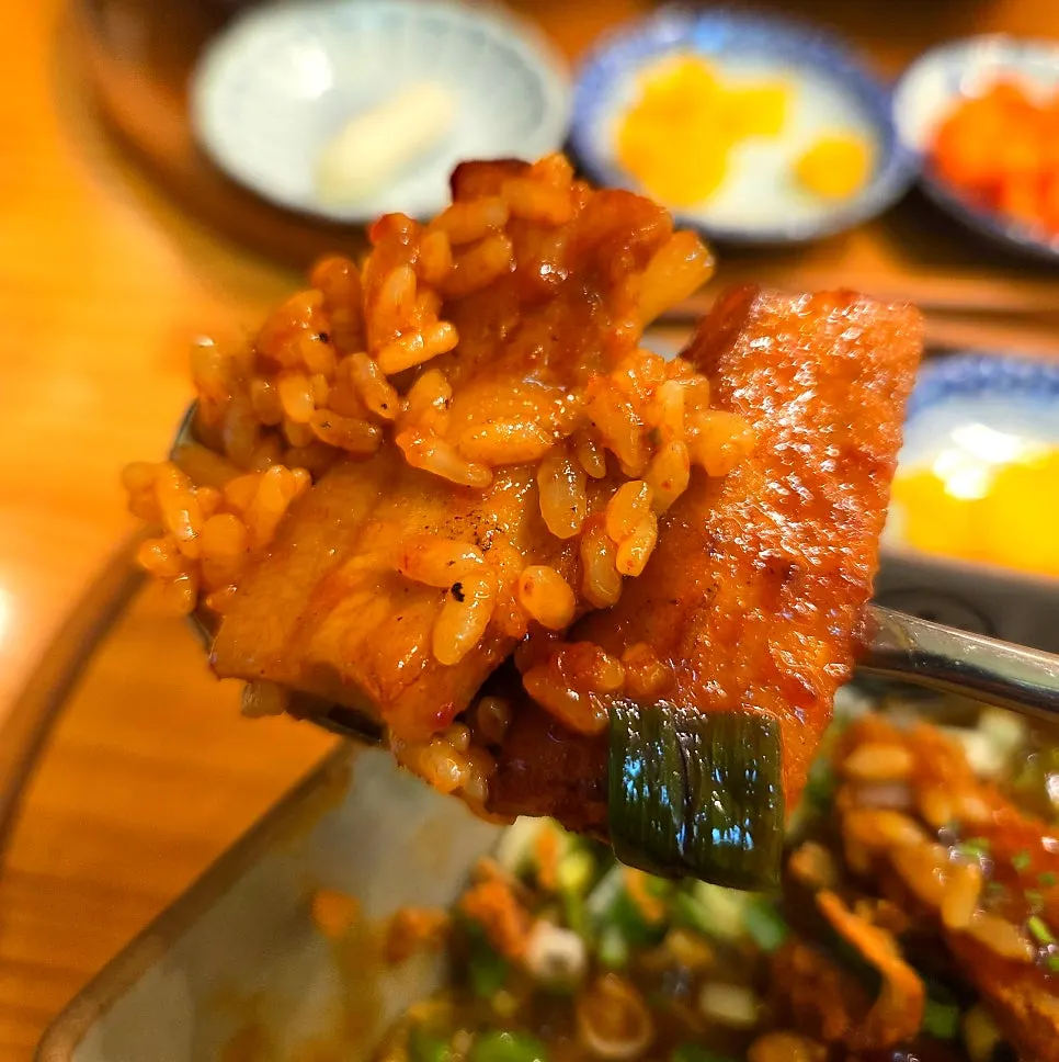 Taking a bite of pork jowl with rice