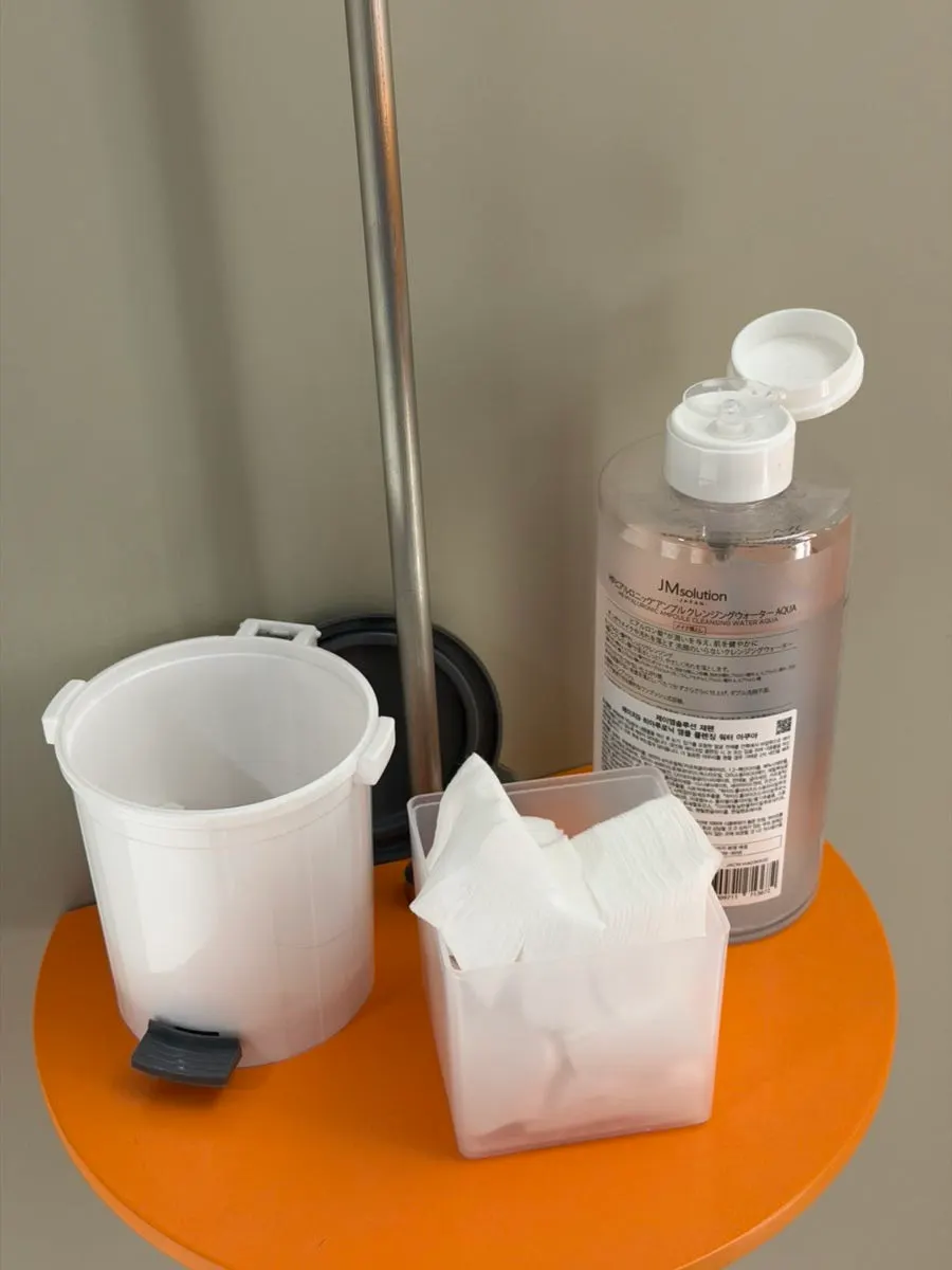Remover and cotton pads set up at the mirror stand