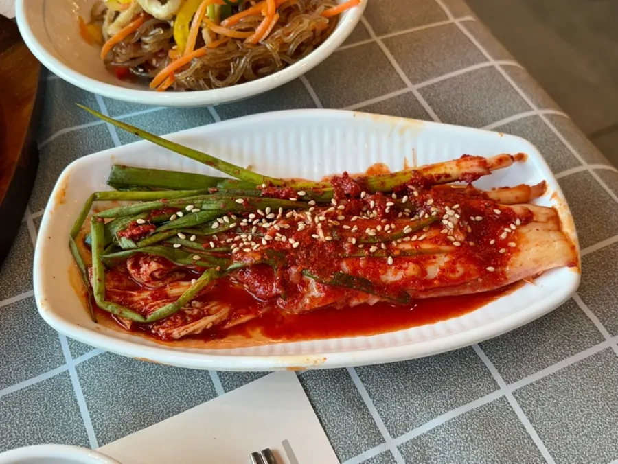 Green onion kimchi, napa cabbage kimchi, and japchae side dishes