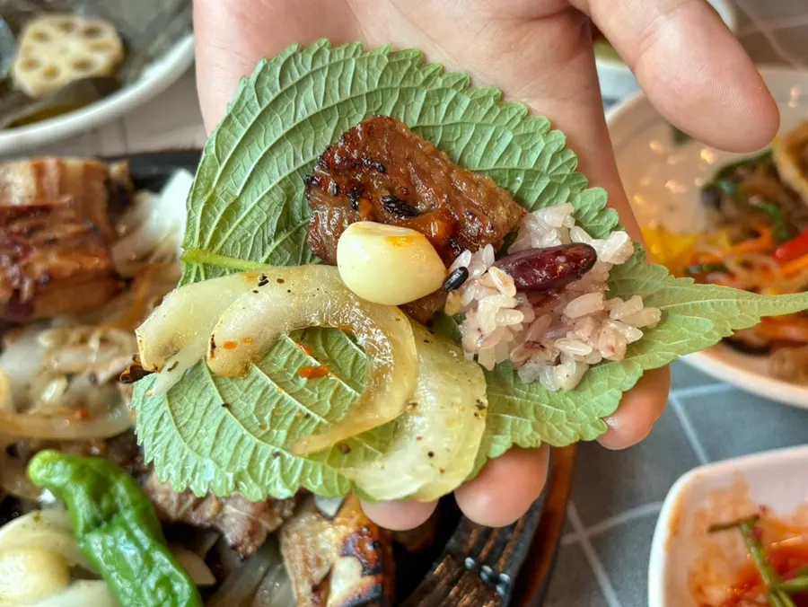 Wood-fired pork galbi wrapped in a lettuce leaf