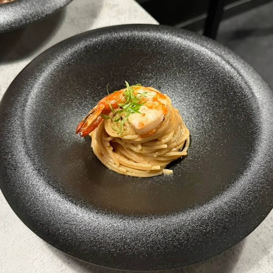 Bisque pasta topped with shrimp