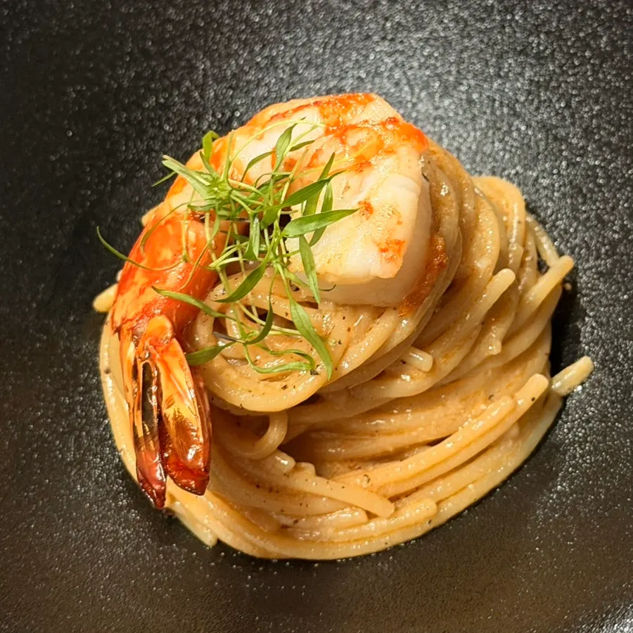 Large shrimp on top of the bisque pasta