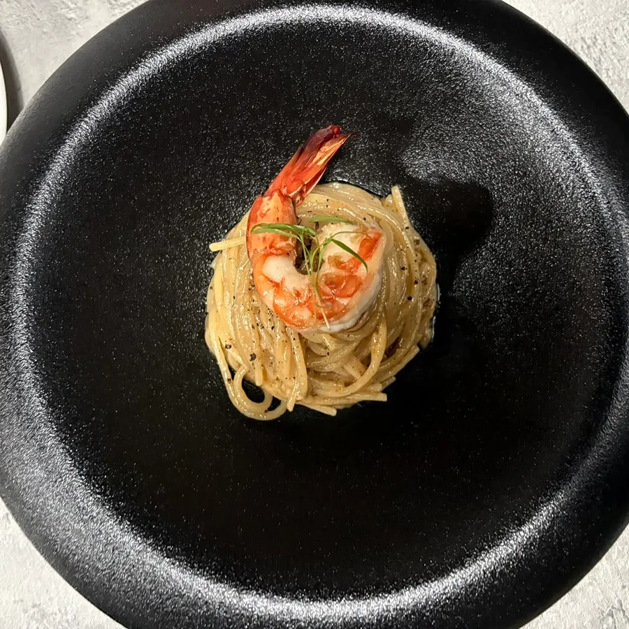 Hado's bisque pasta topped with shrimp